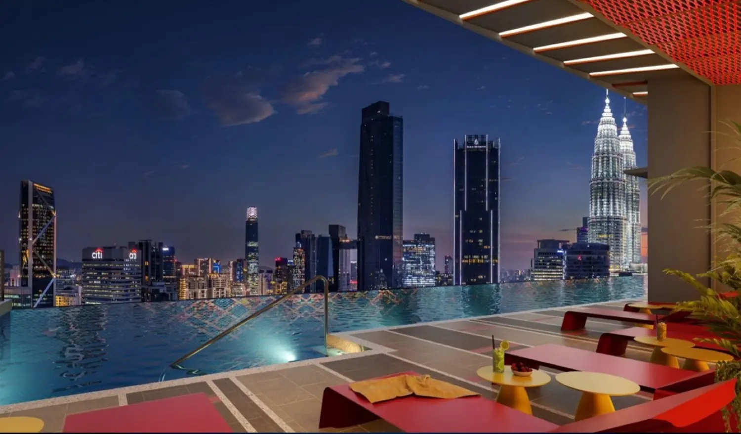 Sky pool and lounge deck at night with KLCC views